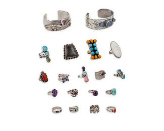 1192 A Group of Silver and Set Stone Set Jewelry Mid/late 20th century Most variously marked for maker and/or for sterling Comprising two silver cuff bracelets, one with set moonstone cabochons and stamp work accents, as well as seventeen set stone silver rings in various styles including classic, modernist and Southwest, featuring various stones including turquoise, amethyst, and coral 19 pieces Cuffs: 6 3/4 in. and 6 1/2 in. total inner C; each: 1 in. H, with a 1 in. gap; Ring sizes: 9 to 6 235.5 grams gross This lot is being offered with no reserve Estimate: $200 - $300