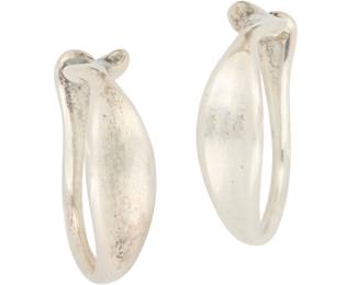 1177 Elsa Peretti for Tiffany & Co.: A Pair of Sterling Silver Hoops The large sculptural abstract ear cuff hoops with tapered and shaped ends, each marked for artist and for sterling 2 pieces Each: 1 1/2 x 1 1/4 in. 16.4 grams This lot is being offered with no reserve Estimate: $300 - $500