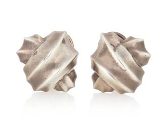 1175 Angela Cummings: A Pair of Silver Ear Clips The two sculptural earrings with knotted design motif and omega pierced ear posts, each marked for artist and for sterling 2 pieces Each: 1 in. Dia. 13.4 grams This lot is being offered with no reserve Estimate: $400 - $600