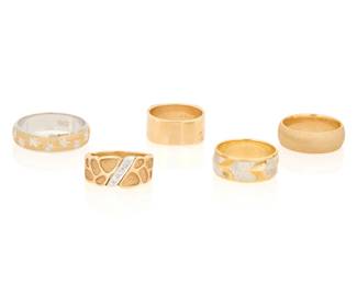 1120 A Group of Five 14K Bi-Color Gold Rings Featuring high polish, textured gold and celestial designs Sizes: 6 - 11 31.5 grams gross Estimate: $2,000 - $3,000