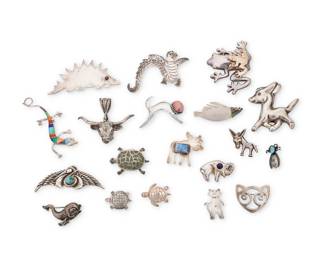 1193 A Group of Silver and Set Stone Figural Jewelry Mid/late 20th century Most variously marked for maker and/or for sterling Comprising eighteen animal pins in various styles such as Native American, Southwest and Mexican including donkeys, frog, a multistone channel lizard, turtles, cats, a crane, a seal, bison, a moose, as well as a silver steer necklace pendant 19 pieces Pendant: 2 1/8 in. H x 2 1/2 in. W; brooches: 3 in. H to 1 in. H 170.0 grams gross This lot is being offered with no reserve Estimate: $200 - $400