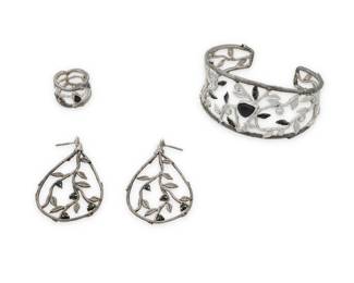 1179 A Silver, Sapphire and Diamond Suite Including a cuff bracelet, ring and pair of earrings, of matching floral design accented by pear-shaped ad round sapphire and round diamonds 4 pieces Cuff: 6 in., 1 in. gap, Ring: 5, Earrings: 2 in. 47.5 grams gross This lot is being offered with no reserve Estimate: $300 - $500