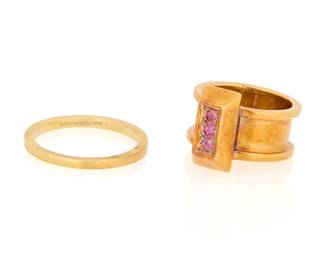1100 Tiffany & Co.: Two Gold Rings Including a 14k gold band signed Tiffany & Co., together with an 18k gold and ruby ring signed Tiffany 2 pieces Sizes: 3 3/4 and 7 14.7 grams gross This lot is being offered with no reserve Estimate: $700 - $900