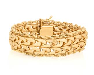 1114 A 14K Gold Bracelet Featuring textured interlocking links finished with gold rope chain Length: 7 3/4 in., Width: 3/4 in. 39.0 grams gross Estimate: $2,500 - $3,500