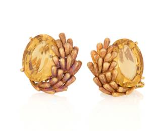 1007 A Pair of 18K Gold and Citrine Earclips Featuring two oval citrines accented by a textured gold spray motif 2 pieces Measures: 3/4 x 5/8 in. 17.6 grams gross This lot is being offered with no reserve Estimate: $1,000 - $1,500