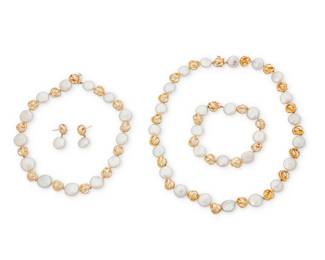 1024 A 14K Gold and Coin Pearl Suite Including two necklaces, a bracelet and pair of earrings featuring coin pearls, accented by organic open style connectors set with single round diamonds 4 pieces Necklaces: 13 in. and 17 in., Bracelet: 7 3/4 in., Earrings: 1 in. 92.9 grams gross Estimate: $1,800 - $2,500