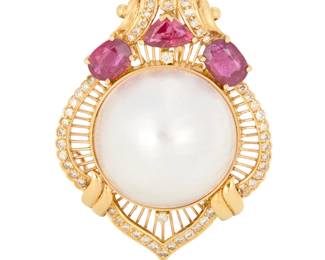 1016 An 18K Gold, Mabe Pearl and Diamond Pendant/Brooch Of an ornate frame design centering a mabe pearl measuring approximately 22.20 mm, accented by oval and triangular-cut rubies finished with round diamonds Measures: 2 x 1 3/8 in. 20.3 grams gross Estimate: $800 - $1,200