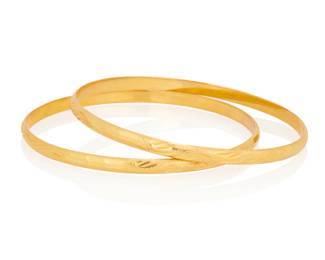 1077 A Pair of 22K Gold Bangles Featuring textured and etched designs 2 pieces Inner circumference: 7 3/4 in. 31.8g Estimate: $3,000 - $5,000