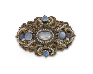 1202 A Gold Filled and Gem-Set Brooch Of an ornate design featuring oval and round moonstone cabochons accented by round sapphires and seed pearls Measures: 2 x 1 1/4 in. 17.6 grams gross This lot is being offered with no reserve Estimate: $300 - $500