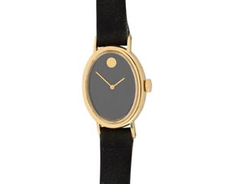 1167 Movado: A 14K Gold Watch Dial: 16.00 mm, oval with a singular gold hour marker Model: Zenith Case: 19.20 mm Closure: black suede bracelet with gold filled buckle clasp Signed: dial, strap with signed box Inner circumference: 5 1/2 - 6 7/8 in. 12.5 grams gross This lot is being offered with no reserve Estimate: $400 - $600