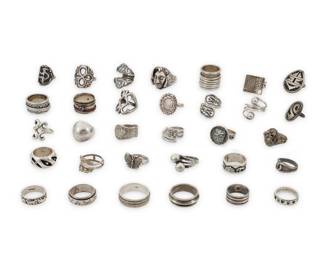 1195 A Group of Silver Rings Mid/late 20th century Most variously marked for maker and/or for sterling Comprising twenty-two silver rings in various styles including classic, modernist, pictorial, and Southwest 32 pieces Ring sizes: 12 1/2 to 4 235.8 grams gross This lot is being offered with no reserve Estimate: $400 - $600