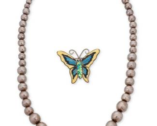 1189 A Group of Mexican Silver Jewelry Comprising a Jerónimo Fuentes sterling silver and multicolored guilloché enamel butterfly brooch, as well as a sterling silver necklace with graduated round beads, each marked for Mexico and for sterling 2 pieces Necklace: 21 in. L; Brooch: 1 1/2 in. x 1 3/4 in. 84.5 grams gross This lot is being offered with no reserve Estimate: $500 - $700
