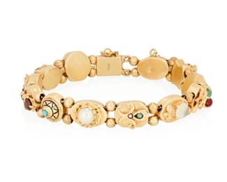 1029 A 14K Gold and Gem-Set Slide Bracelet Featuring sliding links of geometric and floral designs set with jade, coral, citrine, garnet and moonstone Length: 7 in. 33.1 grams gross Estimate: $2,000 - $2,500