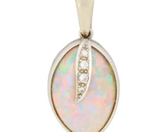 1043 An 18K White Gold, Opal and Diamond Pendant Centering an abstract opal double cabochon measuring approximately 22.41 x 14.10 x 8.63 mm, accented by four graduated round diamonds Measures: 1 1/2 x 5/8 in. 6.0 grams gross This lot is being offered with no reserve Estimate: $500 - $700