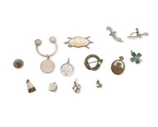 1190 A Group of Diminutive Silver Jewelry Mid/late 20th century Three marked for maker and for sterling Comprising a Tiffany & Co. sterling silver monogrammed charm on an associated key holder, together with three brooches including an F & B sterling gem-set snake brooch/pin, a silver turtle pin with set shell body, and a tiny anchor pin, as well as a double-sided locket pendant with brass-colored figural motifs and shell inlay, a pair of dagger motif earrings, a single silver and set stone collar stud and five silver charms in various designs and sizes 12 pieces Largest: 2 " H; smallest: 1/2" H 38.0 grams gross This lot is being offered with no reserve Estimate: $300 - $500
