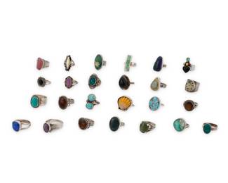 Back to catalog 1197 A Group of Silver and Set Stone Rings Mid/late 20th century Eleven variously marked for maker and/or for sterling Comprising twenty-five set stone and silver rings in various styles including classic, modernist and Southwest, featuring various stones including turquoise, onyx, Mexican fire agate, amethyst, polychrome jasper, dalmatian jasper, azurmalachite, mother of pearl, a small scallop shell, and green hardstone 25 pieces Ring sizes: 10 1/2 to 5 177.5 grams gross This lot is being offered with no reserve Estimate: $300 - $500