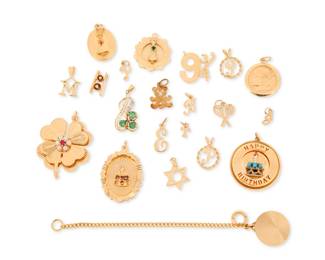 1034 A Group of Gold Charms Including a brides maid charm, happy birthday charms, initials and a clover 20 pieces Measures: 3/8 - 1 1/2 in. 46.0 grams gross Estimate: $2,800 - $3,500