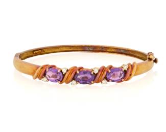 1133 A 14K Gold, Amethyst and Diamond Bracelet Of a hinged design centering three oval amethyst accented by six round diamonds, signed FJG Inner circumference: 6 1/2 in. 16.3 grams gross This lot is being offered with no reserve Estimate: $400 - $600