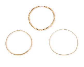 1145 A Group of Three Bi-Color Gold Necklaces Including a white gold and yellow gold omega collar necklace together with a 14k gold bead necklace 3 pieces Lengths: 16 1/2 in., 17 1/2 in. and 18 in. 75.0 grams gross Estimate: $5,000 - $7,000
