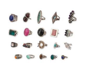 1196 A Group of Silver and Set Stone Rings Mid/late 20th century Most variously marked for maker and/or for sterling Comprising twenty set stone and silver rings in various styles including classic, modernist and Southwest, featuring various stones including turquoise, amethyst, opal, pink agate, Biwa-style pearl, lapis lazuli, mother of pearl, and green hardstone 20 pieces Ring sizes: 10 to 6 198.0 grams gross This lot is being offered with no reserve Estimate: $200 - $400