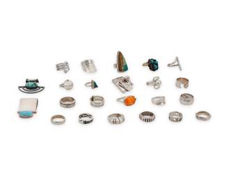 1188 A Group of Silver and Set Stone Jewelry Mid/late 20th century Many variously marked for maker and/or for sterling, including Carlos Diaz Comprising two sterling silver slider pendants, each with set turquoise, as well as twenty-one silver and set stone rings in various styles including classic, modernist and Southwest, featuring various stones including turquoise and orange hardstone 23 pieces Pendants: 2 in. H & 1 1/2 in. H; Ring sizes: 10 to 5 183.1 grams gross This lot is being offered with no reserve Estimate: $400 - $600