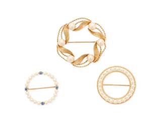 1026 A Group of Three 14K Gold and Cultured Pearl Brooches All of wreath designs featuring seed pearls, cultured pearls and four round sapphires 3 pieces Measures: 1 1/8 in., 1 1/4 in., and 1 5/8 in. 18.8 grams gross Estimate: $800 - $1,200