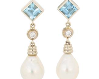 1050 A Pair of 14K White Gold, cultured Pearl and Topaz Earrings Featuring two square step-cut blue topaz suspending two round diamonds and two drop cultured pearls measuring approximately 8.75 mm 2 pieces Measures: 1 1/4 in. 7.0 grams gross Estimate: $700 - $900