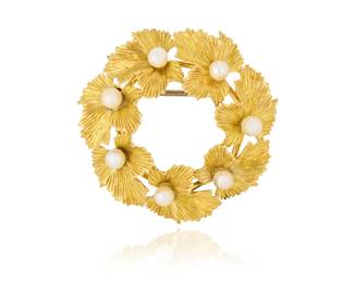 1014 Tiffany & Co.: An 18K Gold and Cultured Pearl Brooch Of a foliate leaf design accented by seven cultured pearls, signed Tiffany & Co. Measures: 1 1/2 x 1 1/2 in. 11.0 grams gross Estimate: $1,000 - $2,000