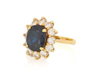 1158 An 18K Gold, Sapphire and Diamond Ring Centering an oval sapphire measuring approximately 8.43 x 6.94 mm, encircled by round diamonds weighing approximately 0.84 carat Size: 2 1/2 4.1 grams gross Estimate: $1,000 - $1,500