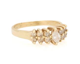 1122 A 14K Gold and Diamond Ring Centering a marquise-cut diamond accidented by tiered round diamonds weighing approximately 0.65 carats total Size: 8 1/2 3.6 grams gross Estimate: $500 - $700
