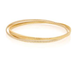 1063 An 18K Tri-Color Gold Bangle Of an interlocking design featuring yellow, rose and white gold Inner circumference: 7 3/4 in. 21.8 grams gross Estimate: $2,500 - $3,500