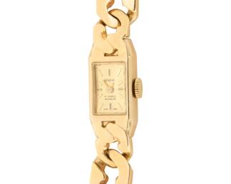 1161 Geneve: A 14K Gold Watch Dial: 7.5mm, rectangular with baton hour markers Case: 10.80 mm Closure: gold Cuban link bracelet Signed: dial Inner circumference: 6 3/4 in. 41.7 grams gross Estimate: $2,000 - $3,000