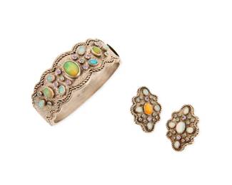 1181 A Sterling Silver, Opal and Colored Diamond Set Including a hinged bangle and pair of earrings featuring rope designs set with oval white opal cabochons accented by round colored diamonds and purple sapphires 3 pieces Bangle: 7 1/2 in., Earrings: 1 1/2 x 1 in. 152.0 grams gross Estimate: $800 - $1,200