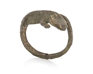 1182 Michael Ozag: A Sterling Silver 'Zyde Gator' Alligator Bracelet The oval cuff with hinged tail clasp, marked for maker and for sterling 6 1/4 in. inner C x 1 3/4 in. W 78.6 grams Estimate: $600 - $800