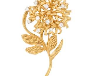 1083 A 14K Gold and Diamond Brooch Of a flower design accented by eleven round diamonds weighing approximately 1.10 carats Measures: 2 1/2 x 1 3/8 in. 21.4 grams gross Estimate: $1,500 - $2,000