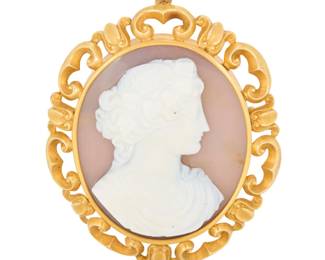 1022 A 14K Gold and Agate Cameo Pendant/Brooch Centering an oval carved agate cameo of a Bacchus motif set in an ornate frame Measures: 1 3/8 x 2 in. 43.9 grams gross This lot is being offered with no reserve Estimate: $2,000 - $3,000