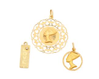 1103 A Group of Three 18K Gold Pendants Including two Nefertiti pendants together with a plaque engraved 'Love and Carol' 3 pieces Measures: 1 1/4 - 2 in. 18.0 grams gross Estimate: $1,500 - $2,000