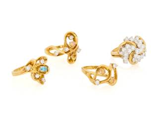 1082 A Group of 18K Gold and Diamond Rings All of swirling designs accented by round near colorless diamonds, round orange diamonds and an oval blue diamond 4 pieces Sizes: 5 1/2, 6 1/4 and 7 36.9 grams gross Estimate: $3,000 - $5,000