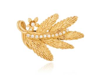 1006 A 14K Gold and Diamond Brooch Of a textured foliate design accented by twelve round diamonds weighing approximately 0.36 carat Measures: 1 7/8 x 1 3/8 in. 15.7 grams Estimate: $1,200 - $1,500