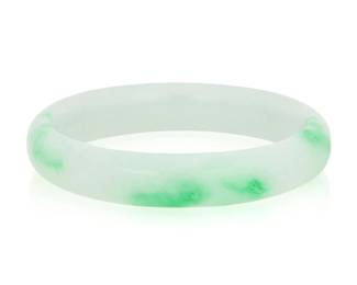 1075 A Jade Bangle Of a variegated green hue Inner circumference: 7 in. 46.2 grams gross This lot is being offered with no reserve Estimate: $400 - $600
