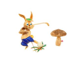 1109 Two 14K Gold Brooches including one of a golfing bunny design accented by red, blue and green enamel together with a mushroom design accented by a single round ruby 2 pieces Measures: 1 x 1 in. and 2 1/2 x 2 1/4 in. 38.9 grams gross Estimate: $1,800 - $2,500