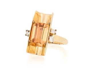 1010 A 14K Gold and Topaz Ring Centering an emerald-cut topaz in an open cylindrical design accented by three round diamonds Size: 7 with hinged shank 7.6 grams gross Estimate: $600 - $800