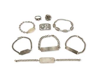1191 A Group of Silver Jewelry 20th century Seven marked for sterling; one marked: Silver Comprising a sterling silver marcasite and gem-set floral brooch, an unmarked silver floral ring with a central rose-cut diamond flanked by two colorless stones, a sterling silver sculptural floral "viola" motif ring, and six silver link and chain link bracelets, most with commemorative or identification monograms 9 pieces Brooch: 7/8" H x 1 1/2" W; rings: sizes 5 & 8; bracelets: 7" L to 6 1/4" L 95.1 grams gross This lot is being offered with no reserve Estimate: $500 - $700