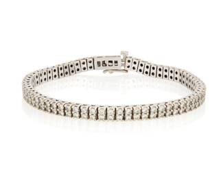 1047 An 18K White Gold and Diamond Bracelet Featuring two rows of round diamonds weighing approximately 4.00 carats Length: 8 in. 28.8 grams gross Estimate: $2,000 - $3,000