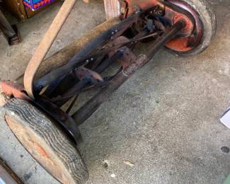 Antique (fully functional) Yard Man manual push mower/grass cutter.