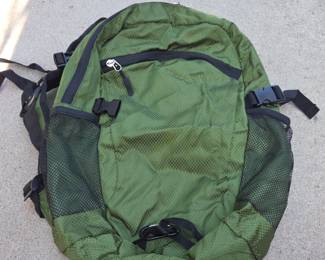 Lot # C99 - Lightweight Compact Foldable Green Backpack with Mesh Side Pockets and Adjustable Straps