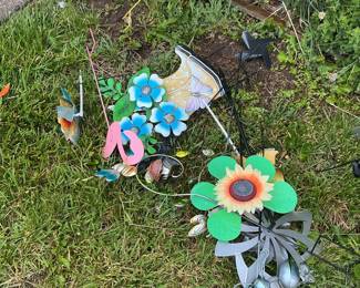 Assorted Metal Garden Ornaments including Wind Spinners, Stakes, and Planters