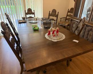 Stanley dining table with two 18” leaves and 8 chairs on casters.