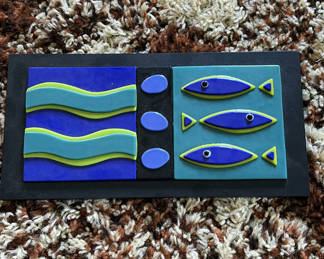 Lot 8: Abstract three-panel wall sculpture with wavy bands and fish motifs