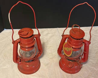 Lot 212: Pair of red vintage Winged Wheel lanterns